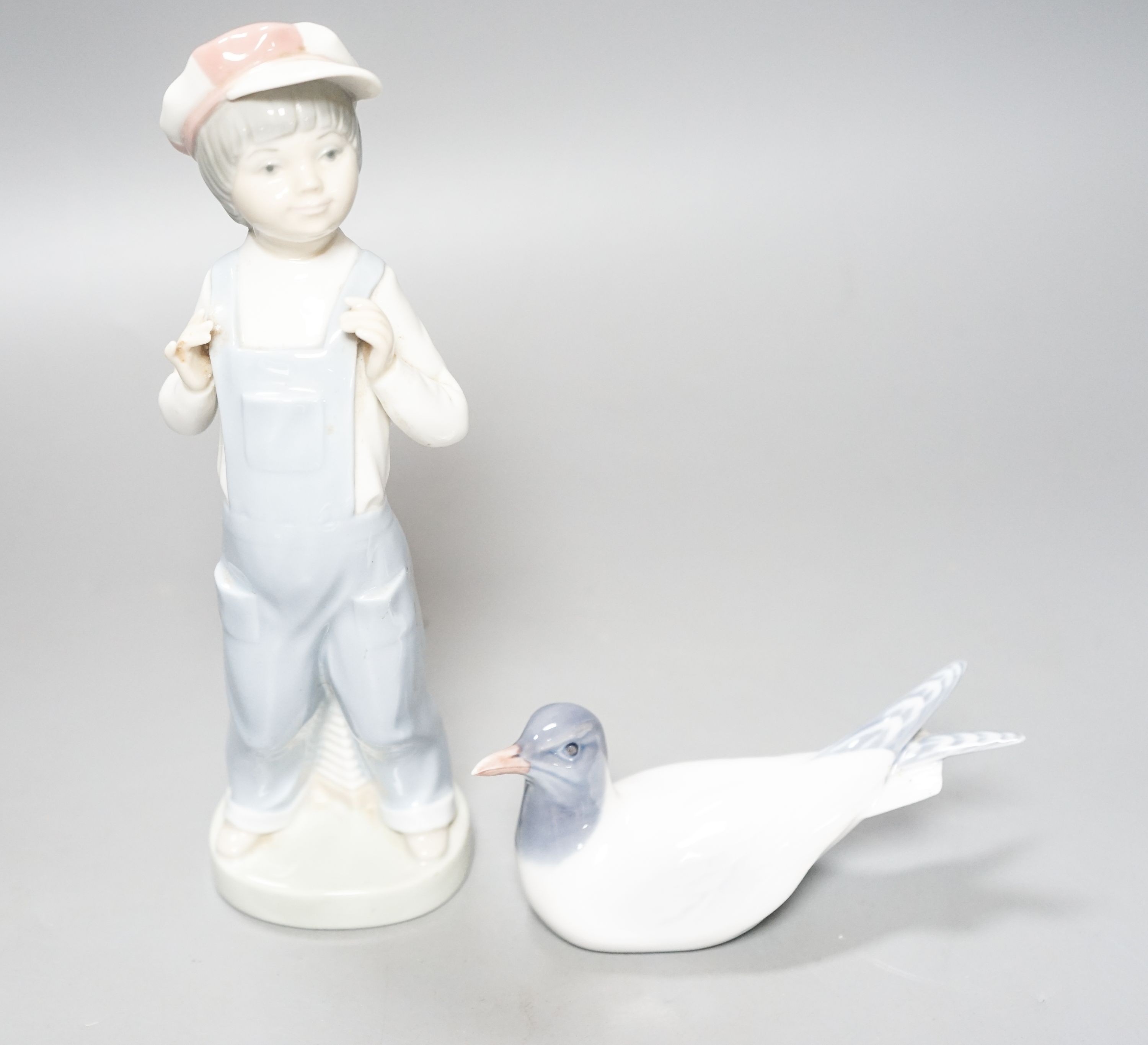 A Lladro figure of a young boy, 21.5cm high, a Royal Copenhagen model a tern, a cased miniature Royal Worcester jug, signed Norway?
